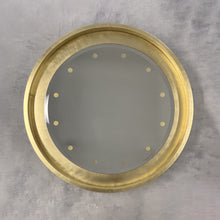 Special edition bevelled Orbis™ round mirror with a floating reflective surface, exquisite handcrafted brushed brass frame and bespoke illumination.