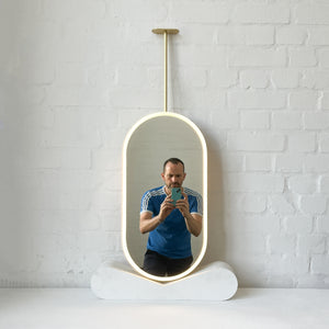Capsula™ Ceiling Suspended Contemporary Mirror with a Brass Frame and Front Illumination
