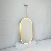 Capsula™ Ceiling Suspended Contemporary Mirror with a Brass Frame and Front Illumination