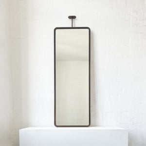 Modern ceiling suspended Quadris™ rectangular mirror with a handcrafted brass frame with a bronze patina finish