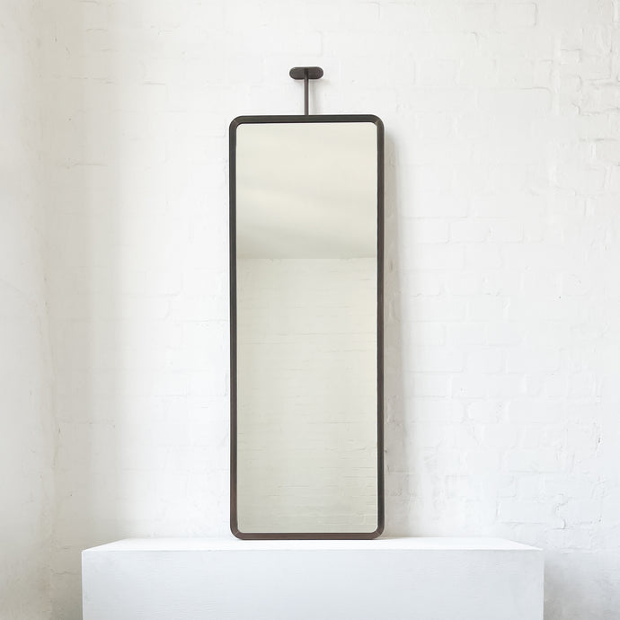 Modern ceiling suspended Quadris™ rectangular mirror with a handcrafted brass frame with a bronze patina finish