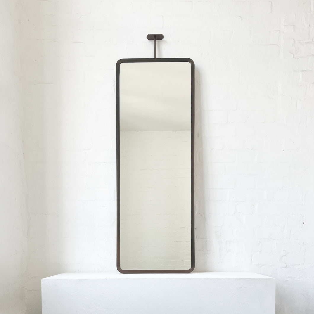 Modern ceiling suspended Quadris™ rectangular mirror with a handcrafted brass frame with a bronze patina finish