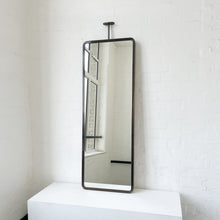 Modern ceiling suspended Quadris™ rectangular mirror with a handcrafted brass frame with a bronze patina finish