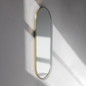 Capsula™ Capsule shaped Modern Mirror with an Elegant Brass Frame