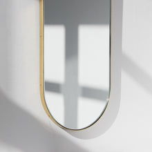 Capsula™ Capsule shaped Modern Mirror with an Elegant Brass Frame