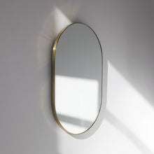 Capsula™ Capsule shaped Modern Mirror with an Elegant Brass Frame