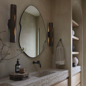 Modern freeform organic shaped mirror with a black powder coated aluminium frame