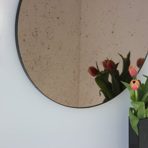 Orbis™ Antiqued Bronze Tinted Round Elegant Mirror with a Black Frame