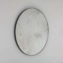 Orbis™ Antiqued Round Mirror with a Handcrafted Bronze Patina Frame