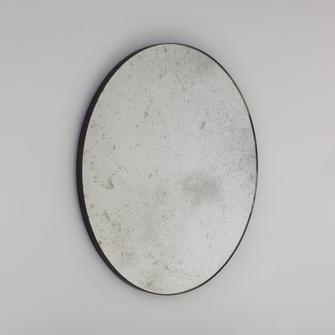 Orbis™ Antiqued Round Mirror with a Handcrafted Bronze Patina Frame