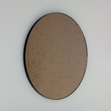 Orbis™ Antiqued Bronze Tinted Round Elegant Mirror with a Black Frame