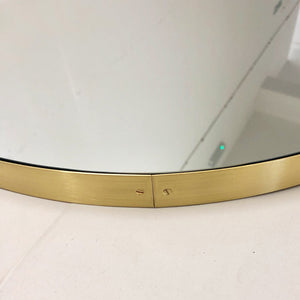 Capsula™ Suspended Capsule shaped Bathroom Mirror with a Brushed Brass Frame
