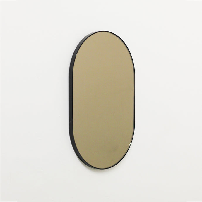 Capsule shaped Bronze Contemporary Mirror with a Black Frame